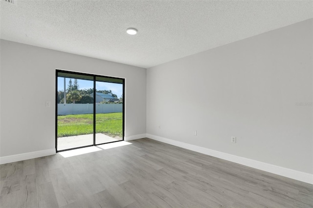 2151 Groveglen Ln S, Lakeland, FL 33813 - spare room featuring a textured ceiling and wood finished floors