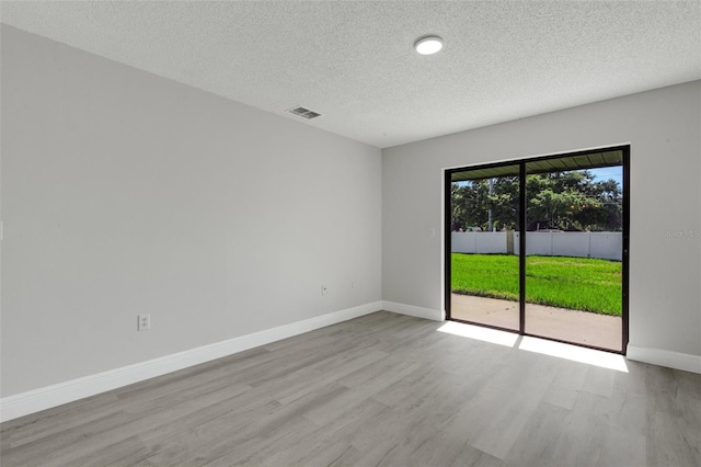 2151 Groveglen Ln S, Lakeland, FL 33813 - spare room featuring wood finished floors and a textured ceiling