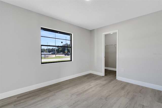 2151 Groveglen Ln S, Lakeland, FL 33813 - unfurnished bedroom with wood finished floors, a walk in closet, and a closet
