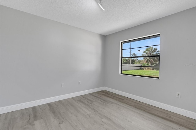 2151 Groveglen Ln S, Lakeland, FL 33813 - empty room featuring wood finished floors and a textured ceiling