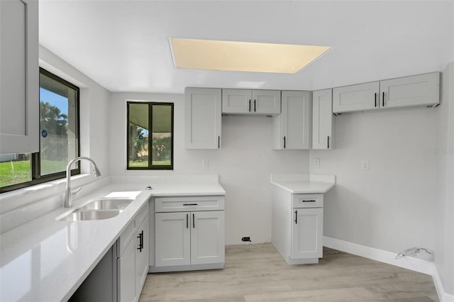 2151 Groveglen Ln S, Lakeland, FL 33813 - kitchen with light stone countertops, light wood-style flooring, and gray cabinetry