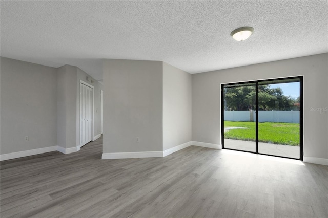 2151 Groveglen Ln S, Lakeland, FL 33813 - empty room featuring wood finished floors and a textured ceiling