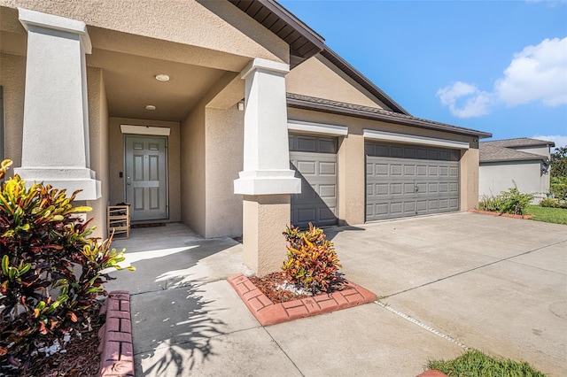 10211 Cakebread Ln, Riverview, FL 33578 - property entrance featuring stucco siding, concrete driveway, and an attached garage