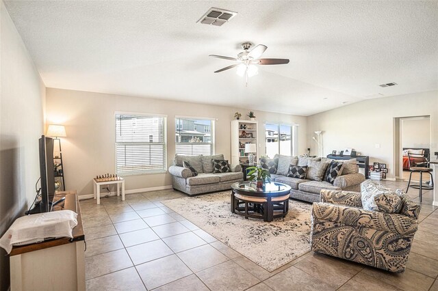 10211 Cakebread Ln, Riverview, FL 33578 - living area featuring a ceiling fan, vaulted ceiling, tile patterned floors, and a textured ceiling