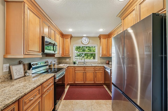 2110 W View Dr, Sun City Center, FL 33573 - kitchen featuring stainless steel appliances, a textured ceiling, light stone countertops, recessed lighting, and brown cabinetry