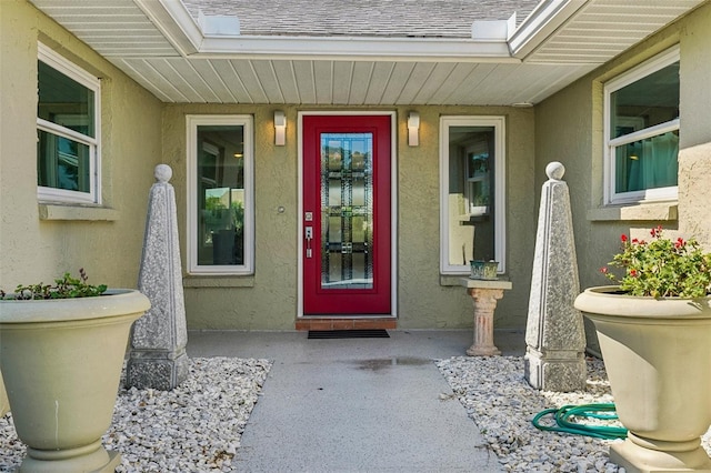 2110 W View Dr, Sun City Center, FL 33573 - doorway to property with stucco siding and roof with shingles