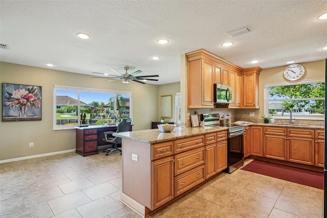 2110 W View Dr, Sun City Center, FL 33573 - kitchen featuring appliances with stainless steel finishes, a desk, healthy amount of natural light, light stone countertops, and recessed lighting
