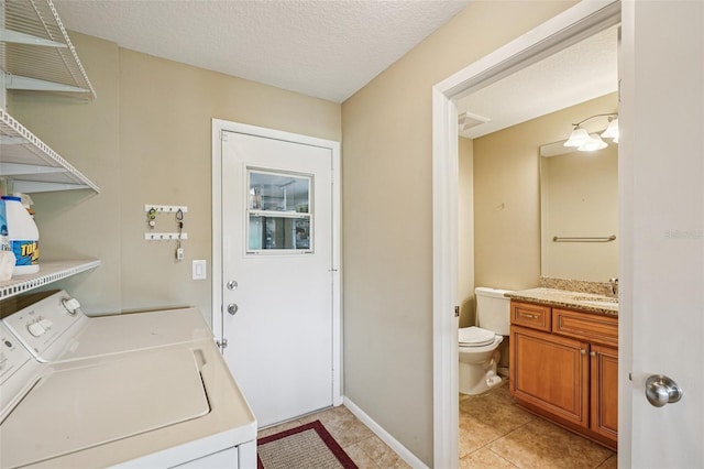 2110 W View Dr, Sun City Center, FL 33573 - laundry room with washer and dryer, light tile patterned floors, and a textured ceiling