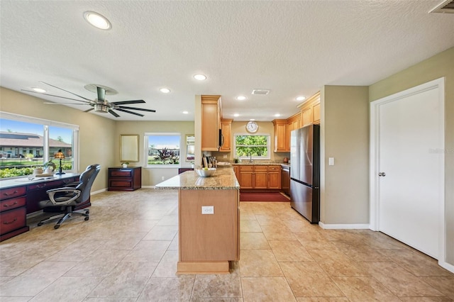 2110 W View Dr, Sun City Center, FL 33573 - kitchen with stainless steel appliances, plenty of natural light, recessed lighting, a peninsula, and light stone countertops