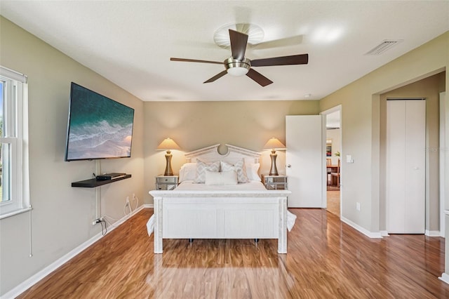 2110 W View Dr, Sun City Center, FL 33573 - bedroom featuring light wood-type flooring, multiple windows, and ceiling fan