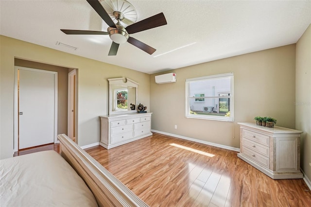 2110 W View Dr, Sun City Center, FL 33573 - bedroom with light wood-style floors, a wall unit AC, and ceiling fan