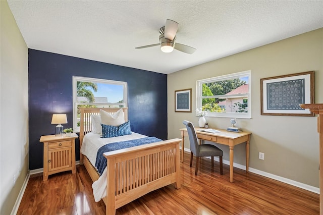 2110 W View Dr, Sun City Center, FL 33573 - bedroom featuring wood finished floors, a textured ceiling, and ceiling fan