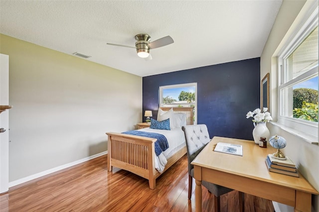 2110 W View Dr, Sun City Center, FL 33573 - bedroom featuring wood finished floors, a ceiling fan, and a textured ceiling