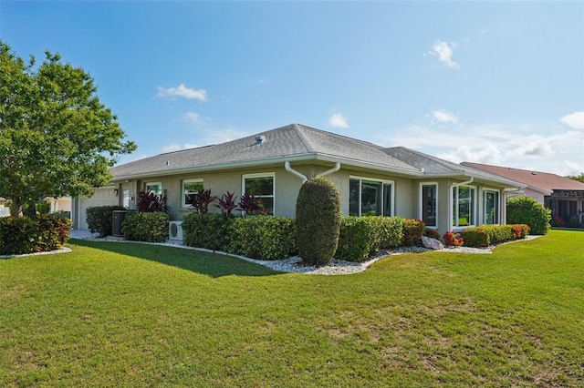 2110 W View Dr, Sun City Center, FL 33573 - view of side of property featuring a garage, a lawn, and stucco siding