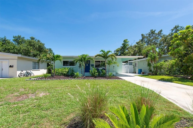 4718 24th Ave S, Saint Petersburg, FL 33711 - view of front of house featuring a front yard, concrete driveway, an attached carport, and stucco siding