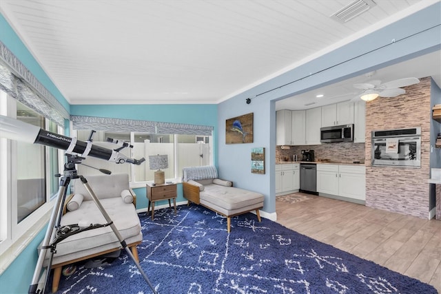 4718 24th Ave S, Saint Petersburg, FL 33711 - living room with wood finished floors, ceiling fan, and crown molding