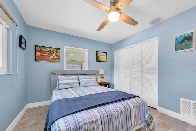 4718 24th Ave S, Saint Petersburg, FL 33711 - bedroom with light wood finished floors, a closet, and a ceiling fan