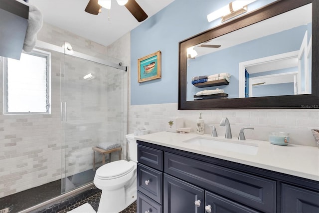 4718 24th Ave S, Saint Petersburg, FL 33711 - bathroom with vanity, tile walls, a shower stall, a ceiling fan, and tile patterned flooring