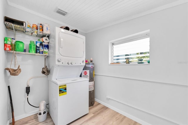 4718 24th Ave S, Saint Petersburg, FL 33711 - laundry area with stacked washer / dryer, water heater, and light wood finished floors