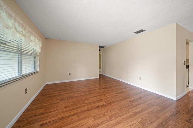 6530 68th St N, Pinellas Park, FL 33781 - spare room with wood finished floors and a textured ceiling