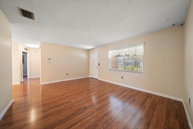 6530 68th St N, Pinellas Park, FL 33781 - unfurnished room featuring a textured ceiling and wood finished floors