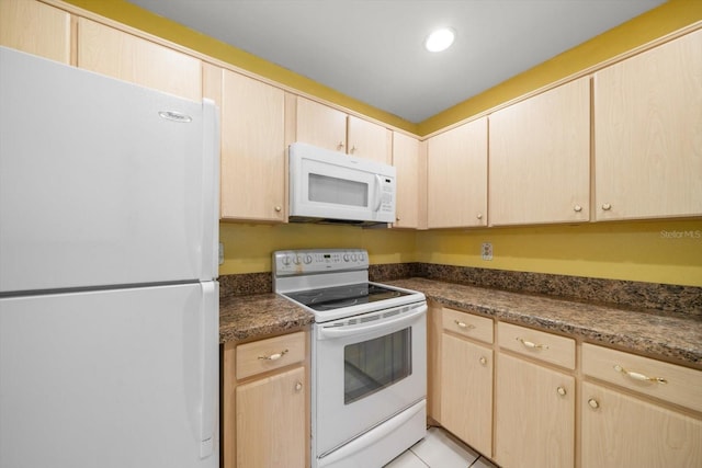6530 68th St N, Pinellas Park, FL 33781 - kitchen with white appliances, light brown cabinets, dark countertops, light tile patterned flooring, and recessed lighting