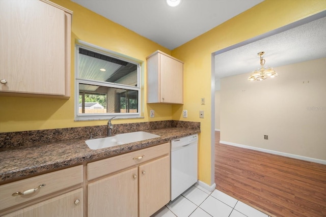6530 68th St N, Pinellas Park, FL 33781 - kitchen with white dishwasher, light brown cabinets, light tile patterned floors, and decorative light fixtures