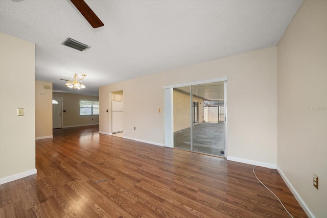 6530 68th St N, Pinellas Park, FL 33781 - spare room with wood finished floors, a ceiling fan, and a chandelier