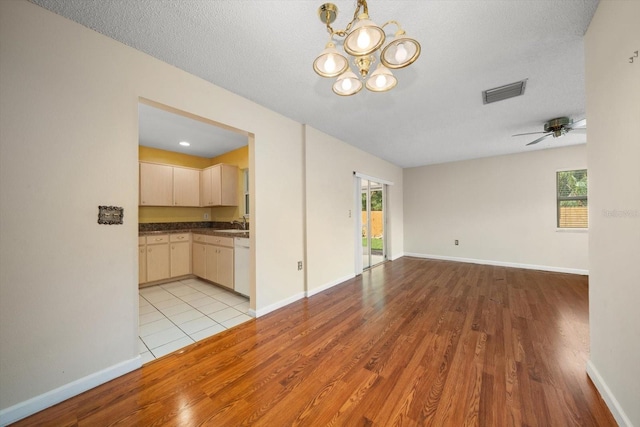 6530 68th St N, Pinellas Park, FL 33781 - unfurnished room featuring plenty of natural light, light wood-type flooring, a chandelier, and a ceiling fan