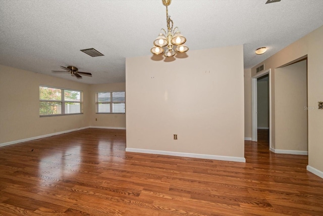6530 68th St N, Pinellas Park, FL 33781 - unfurnished room with a textured ceiling, a chandelier, wood finished floors, and a ceiling fan