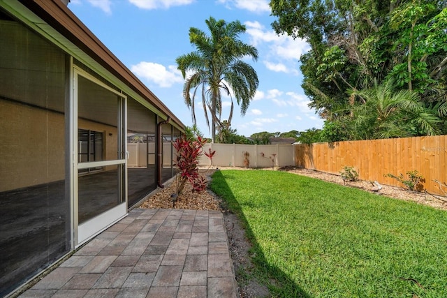 6530 68th St N, Pinellas Park, FL 33781 - fenced backyard featuring a patio and a sunroom
