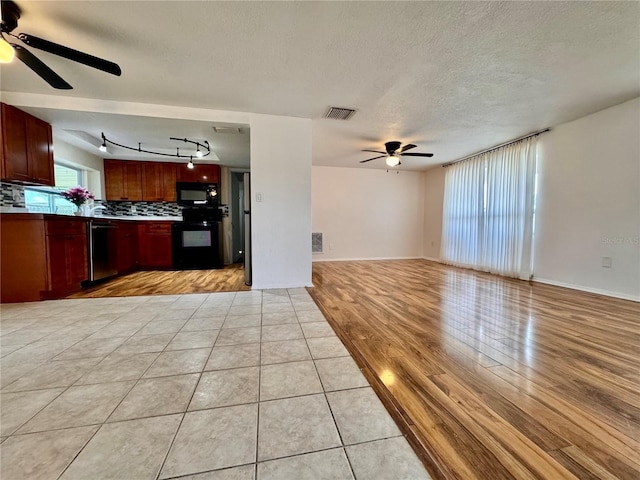 3902 Glissade Dr, New Port Richey, FL 34652 - kitchen featuring black appliances, a ceiling fan, open floor plan, rail lighting, and a textured ceiling