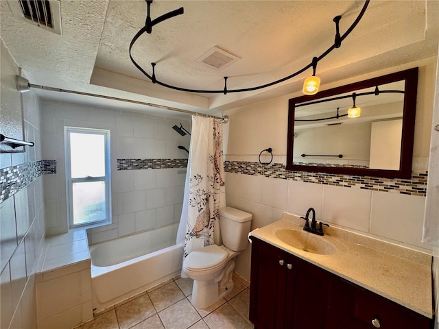3902 Glissade Dr, New Port Richey, FL 34652 - bathroom featuring a textured ceiling, shower / bath combination with curtain, vanity, tile walls, and tile patterned floors