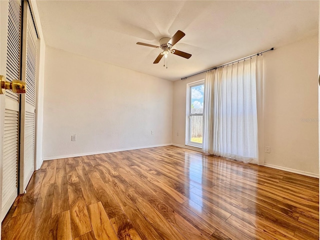3902 Glissade Dr, New Port Richey, FL 34652 - unfurnished bedroom featuring wood finished floors, a ceiling fan, and a closet