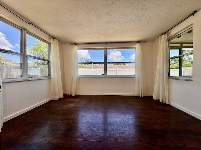 3902 Glissade Dr, New Port Richey, FL 34652 - empty room with a textured ceiling and dark wood-type flooring