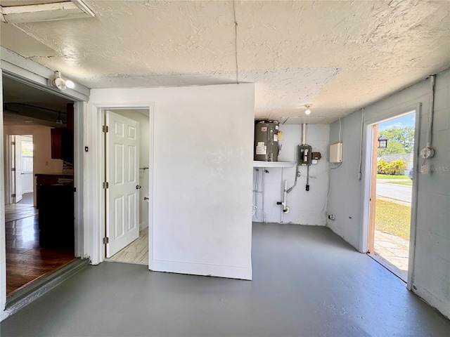 3902 Glissade Dr, New Port Richey, FL 34652 - unfurnished dining area featuring water heater, concrete flooring, plenty of natural light, and a textured ceiling