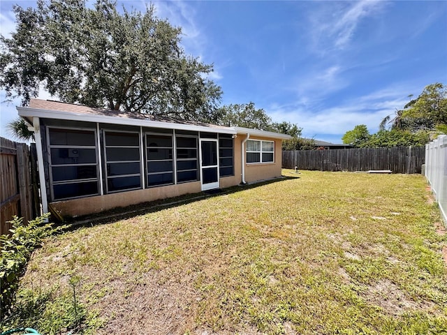3902 Glissade Dr, New Port Richey, FL 34652 - rear view of property with a sunroom and a fenced backyard