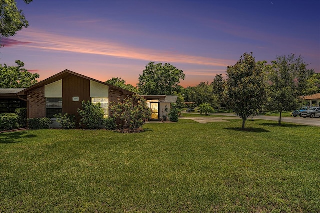 2270 Spruce Ln Unit B, Palm Harbor, FL 34684 - yard at dusk with a lawn