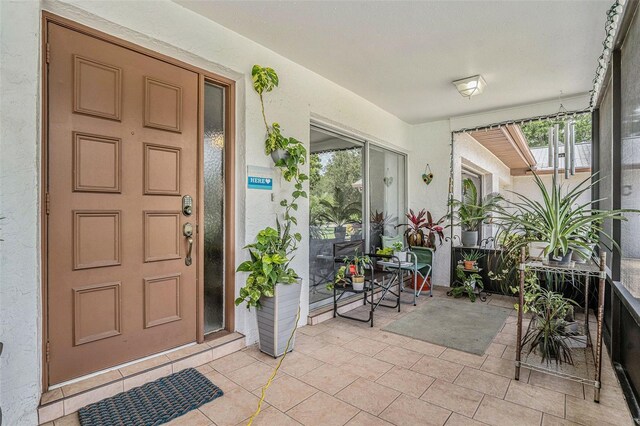 2270 Spruce Ln Unit B, Palm Harbor, FL 34684 - entrance to property with stucco siding and a porch