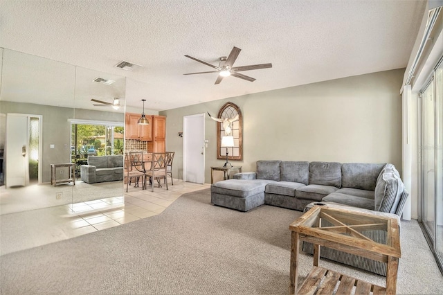2270 Spruce Ln Unit B, Palm Harbor, FL 34684 - living area with a ceiling fan, light colored carpet, light tile patterned flooring, and a textured ceiling