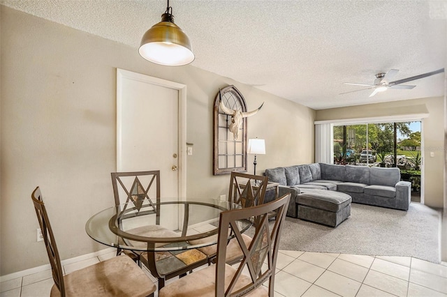 2270 Spruce Ln Unit B, Palm Harbor, FL 34684 - dining space with a textured ceiling, light tile patterned floors, ceiling fan, and light carpet