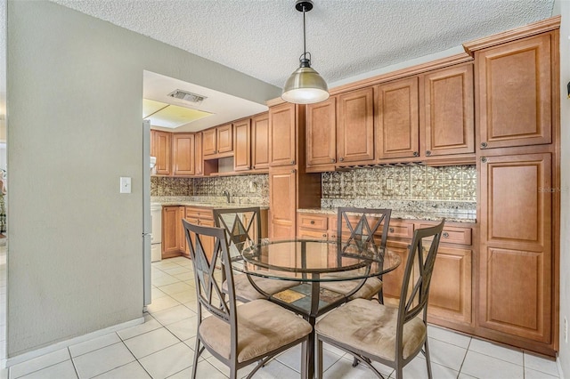 2270 Spruce Ln Unit B, Palm Harbor, FL 34684 - dining area with light tile patterned floors and a textured ceiling