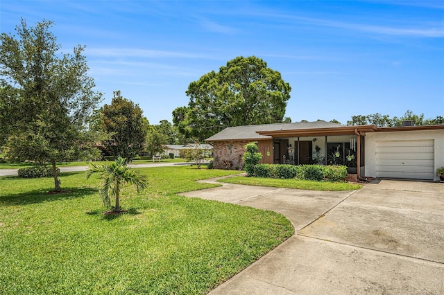 2270 Spruce Ln Unit B, Palm Harbor, FL 34684 - view of front facade featuring driveway, a front lawn, a garage, and stucco siding