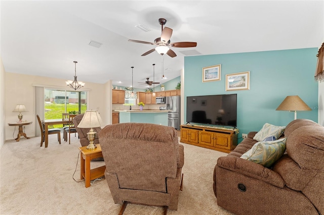 1032 Kelsea Cir, The Villages, FL 32159 - living room featuring light carpet, vaulted ceiling, ceiling fan, and a chandelier