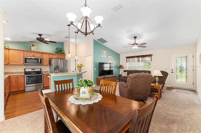 1032 Kelsea Cir, The Villages, FL 32159 - dining area featuring a ceiling fan, lofted ceiling, light colored carpet, and a chandelier