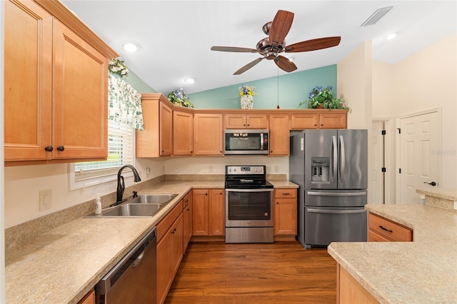1032 Kelsea Cir, The Villages, FL 32159 - kitchen with appliances with stainless steel finishes, vaulted ceiling, dark wood-style flooring, light countertops, and ceiling fan