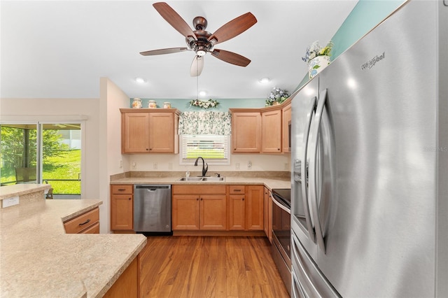 1032 Kelsea Cir, The Villages, FL 32159 - kitchen featuring stainless steel appliances, light countertops, wood finished floors, a ceiling fan, and recessed lighting