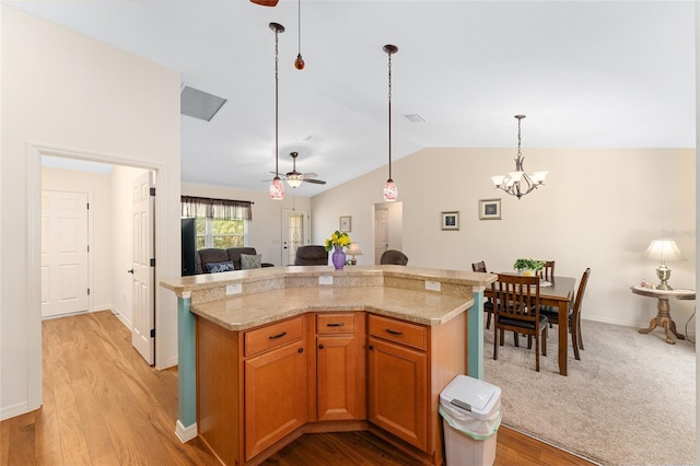 1032 Kelsea Cir, The Villages, FL 32159 - kitchen featuring a ceiling fan, vaulted ceiling, open floor plan, a chandelier, and hanging light fixtures