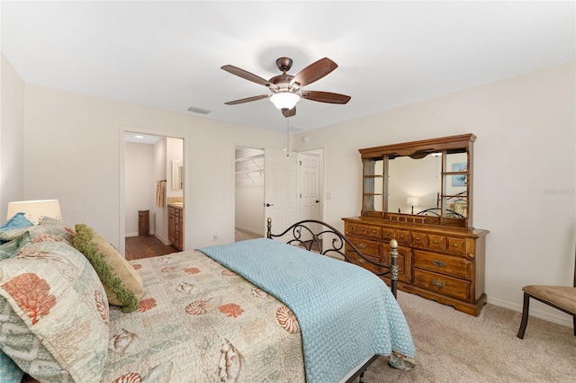 1032 Kelsea Cir, The Villages, FL 32159 - bedroom featuring a ceiling fan, a closet, connected bathroom, and a walk in closet