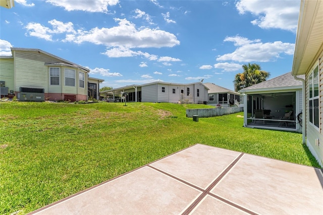 1032 Kelsea Cir, The Villages, FL 32159 - view of grassy yard with a sunroom and a patio area